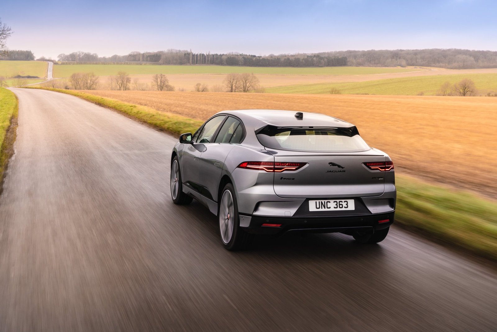 A photo of a Jaguar I-Pace driving on a road.